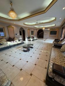 a large living room with couches and a table at فيلا للإيجار اليومي جدة jar villa in Al Kura