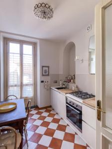 a kitchen with a table and a stove top oven at L'Angolo di Casa Verrua in Turin