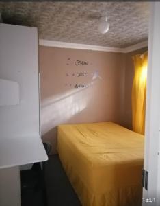 a room with a bed with a writing on the wall at GLOBAL PRIDE in Soweto
