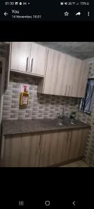 a kitchen with white cabinets and a sink at GLOBAL PRIDE in Soweto