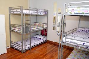 two bunk beds in a room with wooden floors at Hostel Santander in Santander