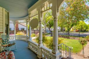 a large porch with white columns and a yard at Lodi Hill House in Lodi