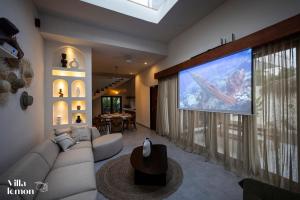 a living room with a large flat screen tv at Beach Villas Canggu 300m from Echo Beach in Canggu