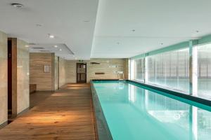 a large swimming pool in a building at QV Apartment Overlooking the Viaduct (1137) in Auckland
