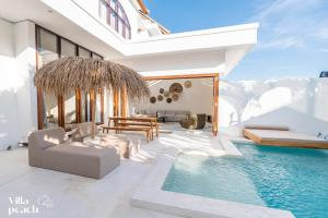 a villa with a swimming pool and a living room at Beach Villas Canggu 300m from Echo Beach in Canggu