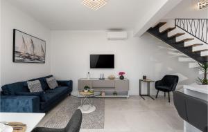 ein Wohnzimmer mit einem blauen Sofa und einem TV in der Unterkunft Villa Cincin in Raša
