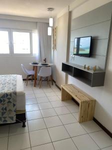 Habitación con cama, mesa y TV. en Flat com vista para o mar - Ponta Negra, en Natal