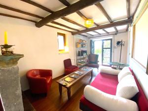 a living room with a couch and a table at Accogliente Dimora Panoramica Civita di Bagnoregio in Bagnoregio