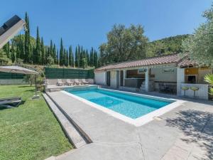 a swimming pool in the backyard of a house at Villa with swimming pool within the Luberon in Oppède