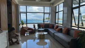 a living room with a couch and a view of the water at Outback Holiday Resort in Honiara