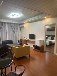 a living room with a couch and a bed at Outback Holiday Resort in Honiara