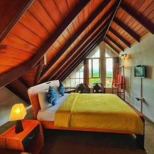 ein Schlafzimmer mit einem großen Bett im Dachgeschoss in der Unterkunft Dewdrops at Lake Gregory in Nuwara Eliya
