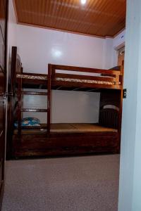 a room with two bunk beds in a room at robiants apartment in Kinatilan
