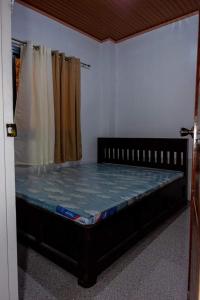 a bedroom with a bed in a room at robiants apartment in Kinatilan