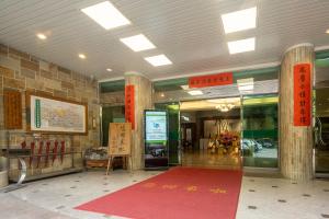 a lobby with a red carpet in front of a building at Ginkgo Hotel in Lugu
