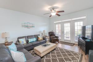 a living room with a couch and a flat screen tv at Seaside at Anastasia C203 in St. Augustine