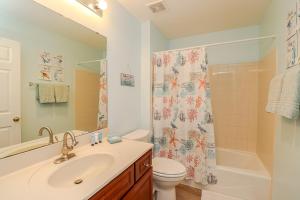 a bathroom with a sink and a toilet and a shower at Seaside at Anastasia C203 in St. Augustine +28 photos