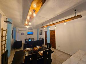 a living room with a table and a dining room at Lovely Inn in San Cristobal
