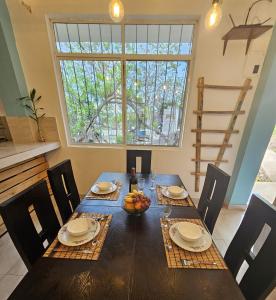 a dining room with a table with chairs and a window at Lovely Inn in San Cristobal