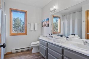 a white bathroom with a sink and a toilet at Lodge at Mount Rushmore in Keystone