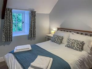 a bedroom with a large bed with a window at Priory Stile in Haverfordwest