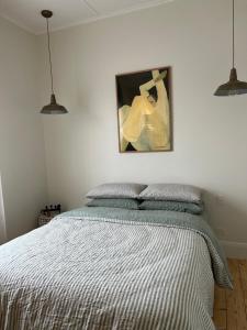 a bedroom with a bed and a painting on the wall at Cozy 2 bedroom cottage - Newly renovated, perfect location for best of Ballarat in Ballarat