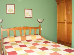 a bedroom with a bed with a checkered floor at Los Olmos Holiday Home in Fuentidueña