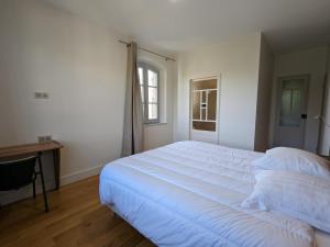 a bedroom with a large white bed and a desk at Loft lumineux avec cuisine équipée et circuits truffes - Centre-ville Jarnac - FR-1-653-248 in Jarnac +19 photos