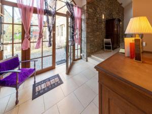 a living room with a purple chair and a table at Charming holiday home in Durbuy with garden in Durbuy