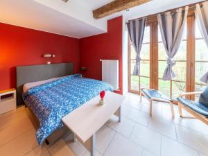 a bedroom with a bed and a table and chairs at Charming holiday home in Durbuy with garden in Durbuy