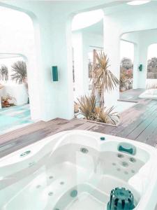 a large white bath tub in a room at La bella tagaytay- Casa Raffa in Tagaytay
