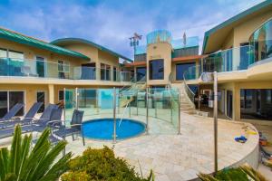 a view of a building with a swimming pool at Stunning Oceanfront Boardwalk Condo - Spa, Steps2Beach, Parking & Fast Wifi! in San Diego