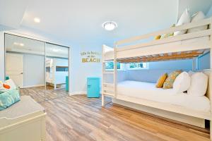 a bedroom with two bunk beds and a mirror at Stunning South Mission Home with Private Rooftop & Ocean Views! in San Diego