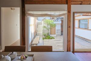 a dining room with a table and a large window at StayMoire Entire Hanok - Central of Seoul in Seoul