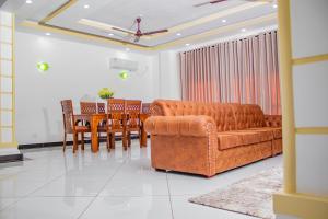 a living room with a couch and a table and chairs at Destiny homes in Mombasa