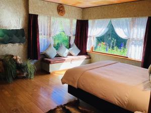 a bedroom with a bed and a window seat at Little Paradise Lodge in Creighton