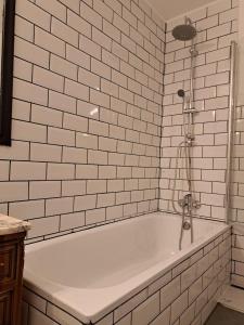 a bath tub in a bathroom with white tiles at Chueca Modern Apartment in Madrid