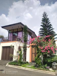 a house with flowers in front of it at Vimala Hills FARLA Villa - 3BR in Gadok 1