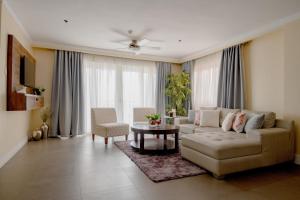a living room with a couch and a table at Sta Barbara Residence Hotel in Cebu City