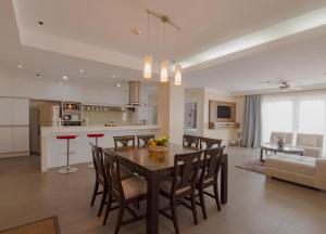 a kitchen and living room with a table and chairs at Sta Barbara Residence Hotel in Cebu City