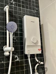 a soap dispenser on a tiled bathroom floor at Beacon Executive Suite - City View - By IZ in George Town