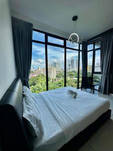 a bedroom with a large bed with a large window at Beacon Executive Suite - City View - By IZ in George Town