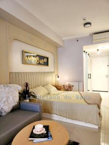 a living room with a bed and a coffee table at SMDC Wind: T2 La Maison du Basa in Tagaytay