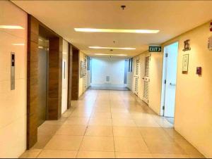 a hallway of an office building with a long corridor at SMDC Wind: T2 La Maison du Basa in Tagaytay