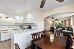a kitchen and living room with a table and chairs at Pacific Oasis - Large Patio, Parking & Walk to Beach in San Diego