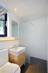 a bathroom with a white sink and a mirror at Jejutokki in Seogwipo