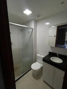 a bathroom with a shower and a toilet and a sink at Flat - solar do atlântico in João Pessoa