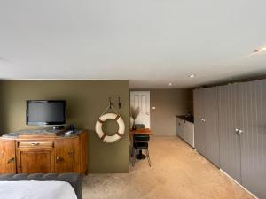 a bedroom with a bed and a flat screen tv at Amster Houseboat Bed without Breakfast in Amsterdam