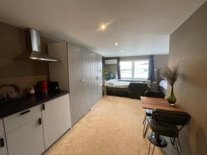 a kitchen and a living room with a table at Amster Houseboat in Amsterdam