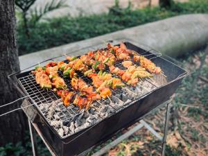 a bunch of food cooking on a grill at Phu Ninh Lake Resort & Spa in Tam Ky